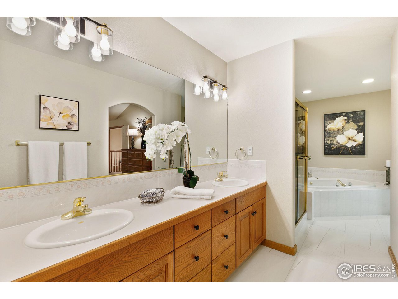 32593 Stagecoach Road Windsor, CO 80550 - Photo 22 of 28 a bathroom with a granite countertop sink mirror and bathtub