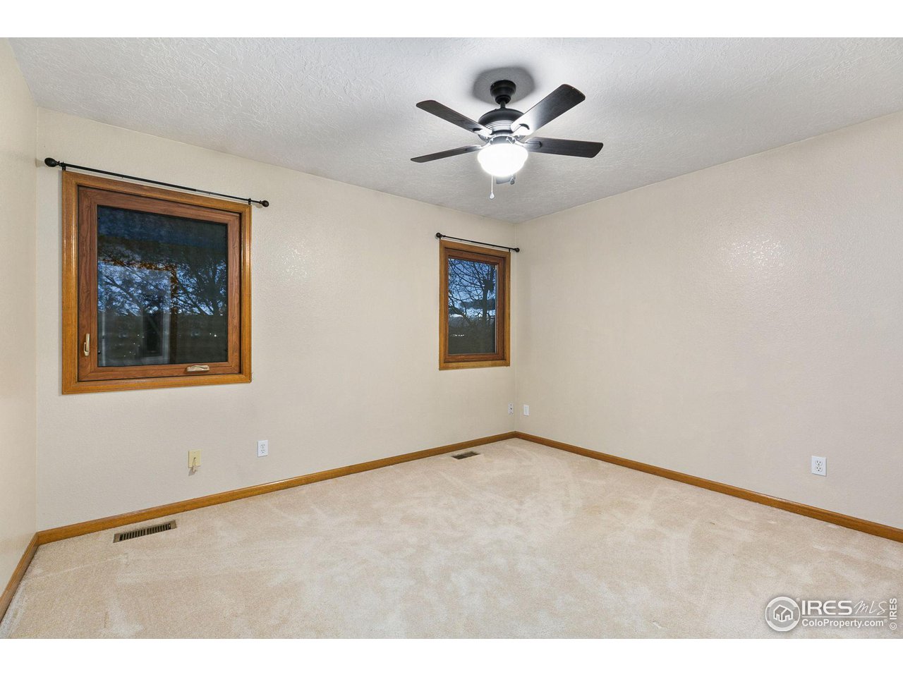 32593 Stagecoach Road Windsor, CO 80550 - Photo 24 of 28 a view of an empty room with wooden floor