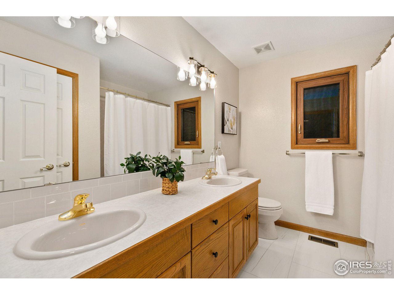 32593 Stagecoach Road Windsor, CO 80550 - Photo 25 of 28 a bathroom with a sink double vanity granite and a mirror