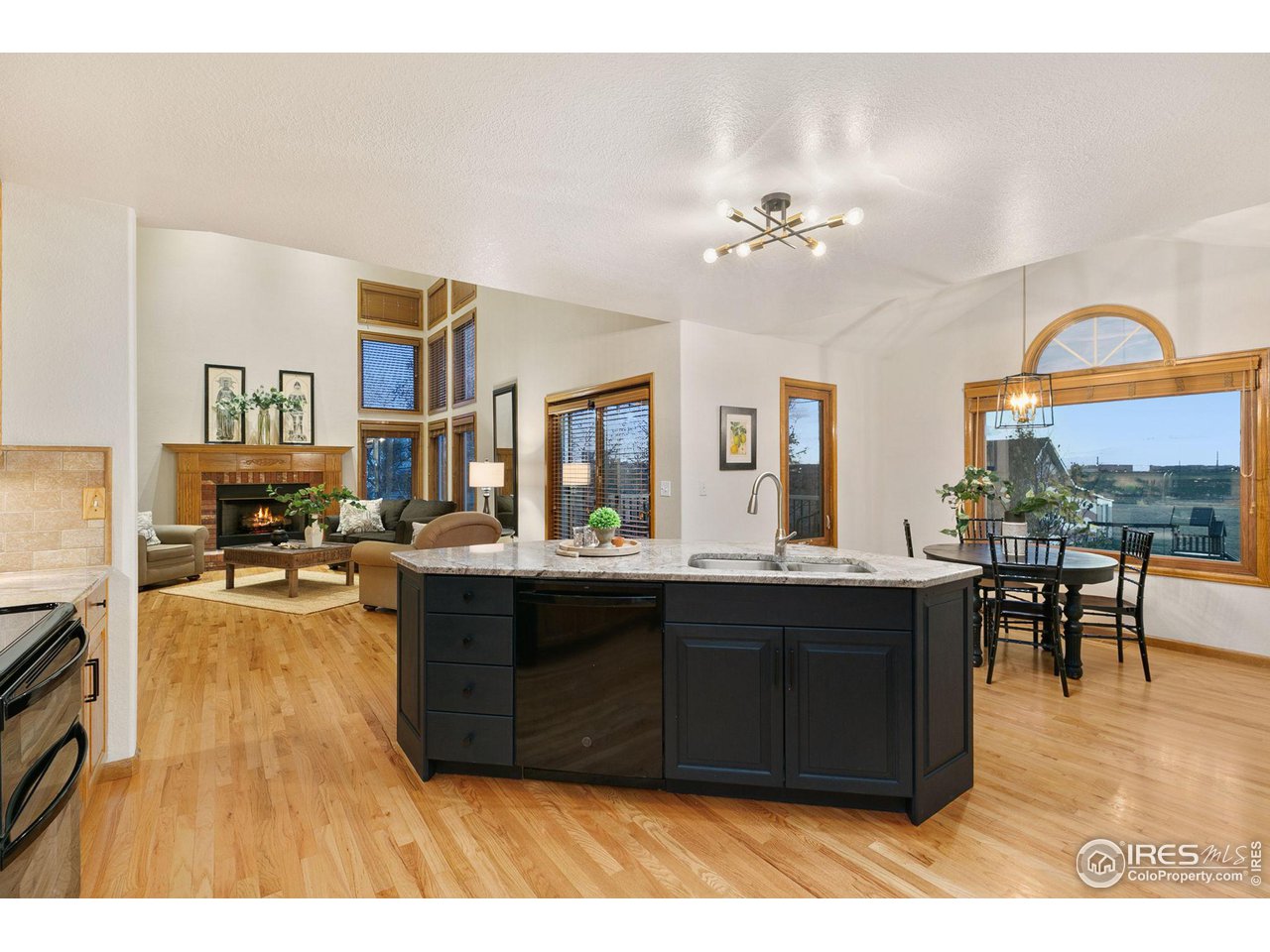 32593 Stagecoach Road Windsor, CO 80550 - Photo 3 of 28 a view of living room kitchen with granite countertop living room