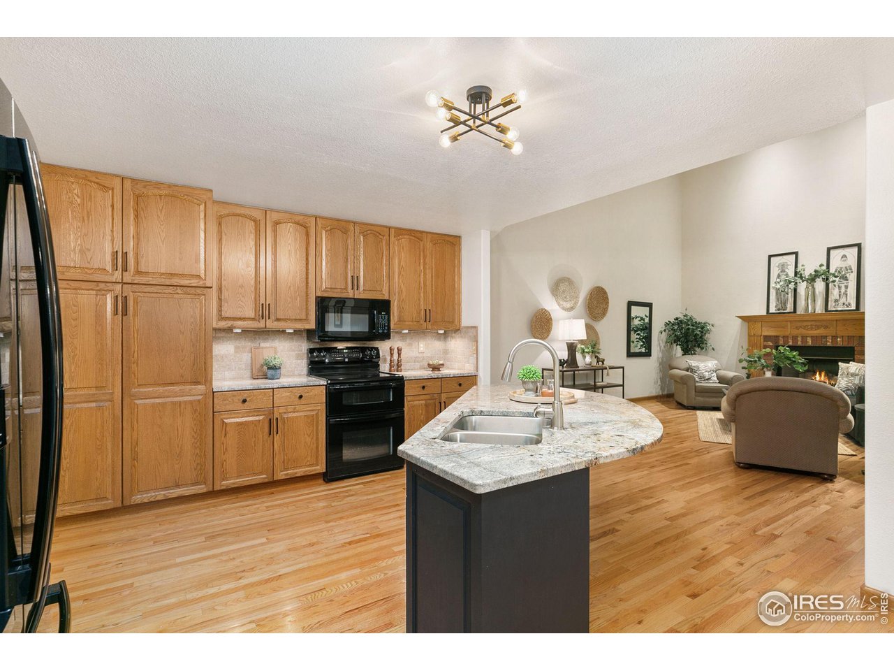 32593 Stagecoach Road Windsor, CO 80550 - Photo 4 of 28 a kitchen with kitchen island granite countertop a sink cabinets and stainless steel appliances