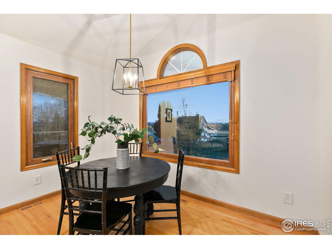32593 Stagecoach Road Windsor, CO 80550 - Photo 6 of 28 a view of a dining room with furniture and wooden floor
