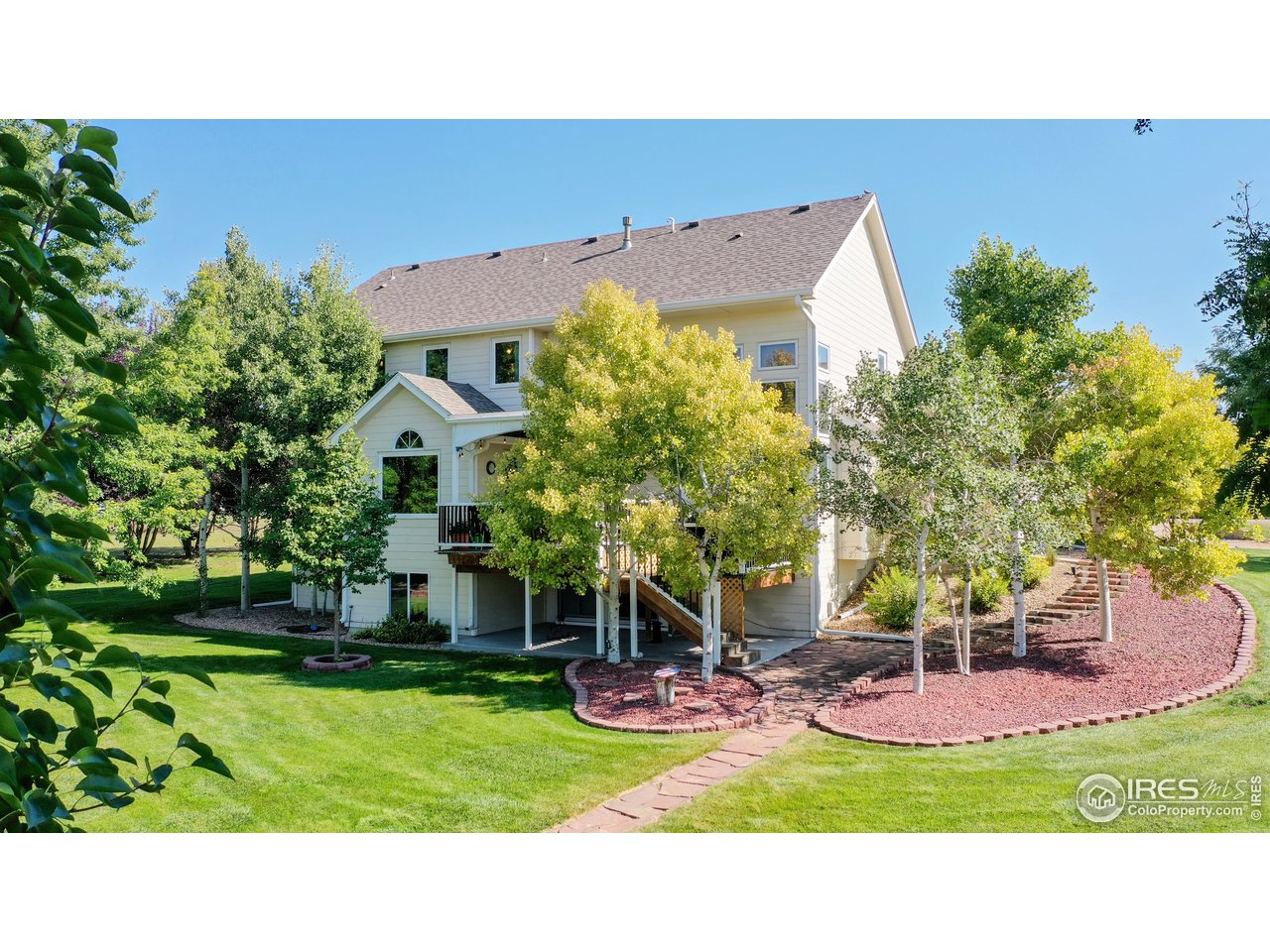 32593 Stagecoach Road Windsor, CO 80550 - Photo 8 of 28 a view of a house with a yard and potted plants