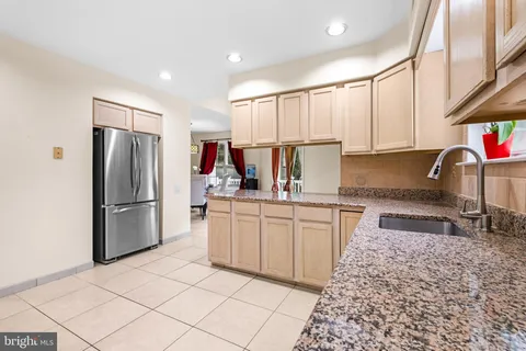 a kitchen with refrigerator and cabinets