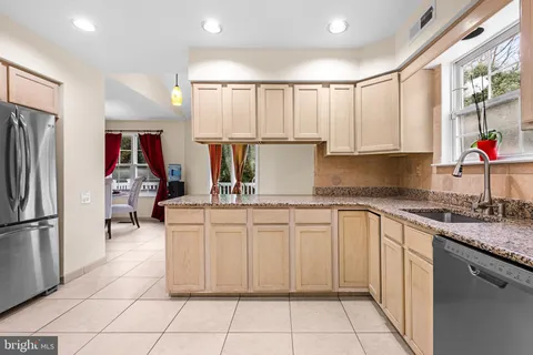 a kitchen with a refrigerator and a sink