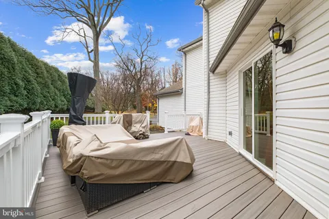 a bed sitting in a balcony with wooden floor