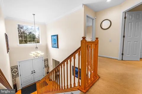 a view of a hallway with wooden floor and windows