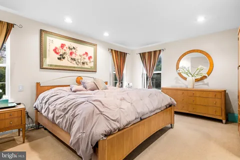 a bed room with a bed and a painting on the wall