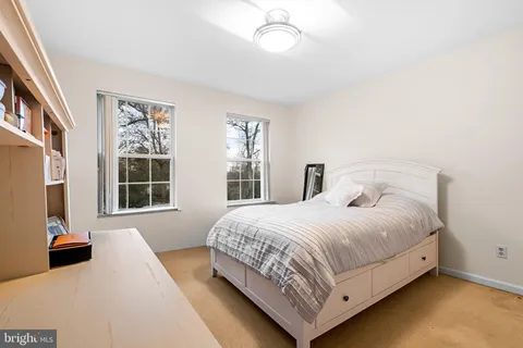 a bedroom with a large bed and a large window