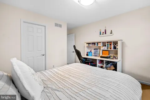 a bedroom with a bed and a bookshelf