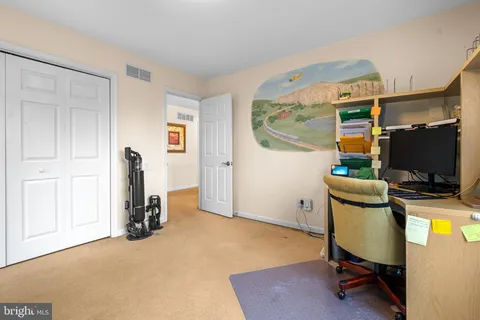 a view of a workspace with furniture and a flat screen tv