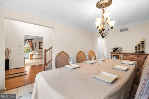 a very nice looking dining room with a table chairs and chandelier