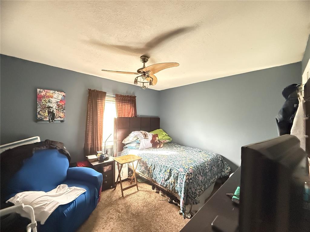 1944 South Conway Road, Unit 3 Orlando, FL 32812 - Photo 15 of 20 a bedroom with a bed couch and a window