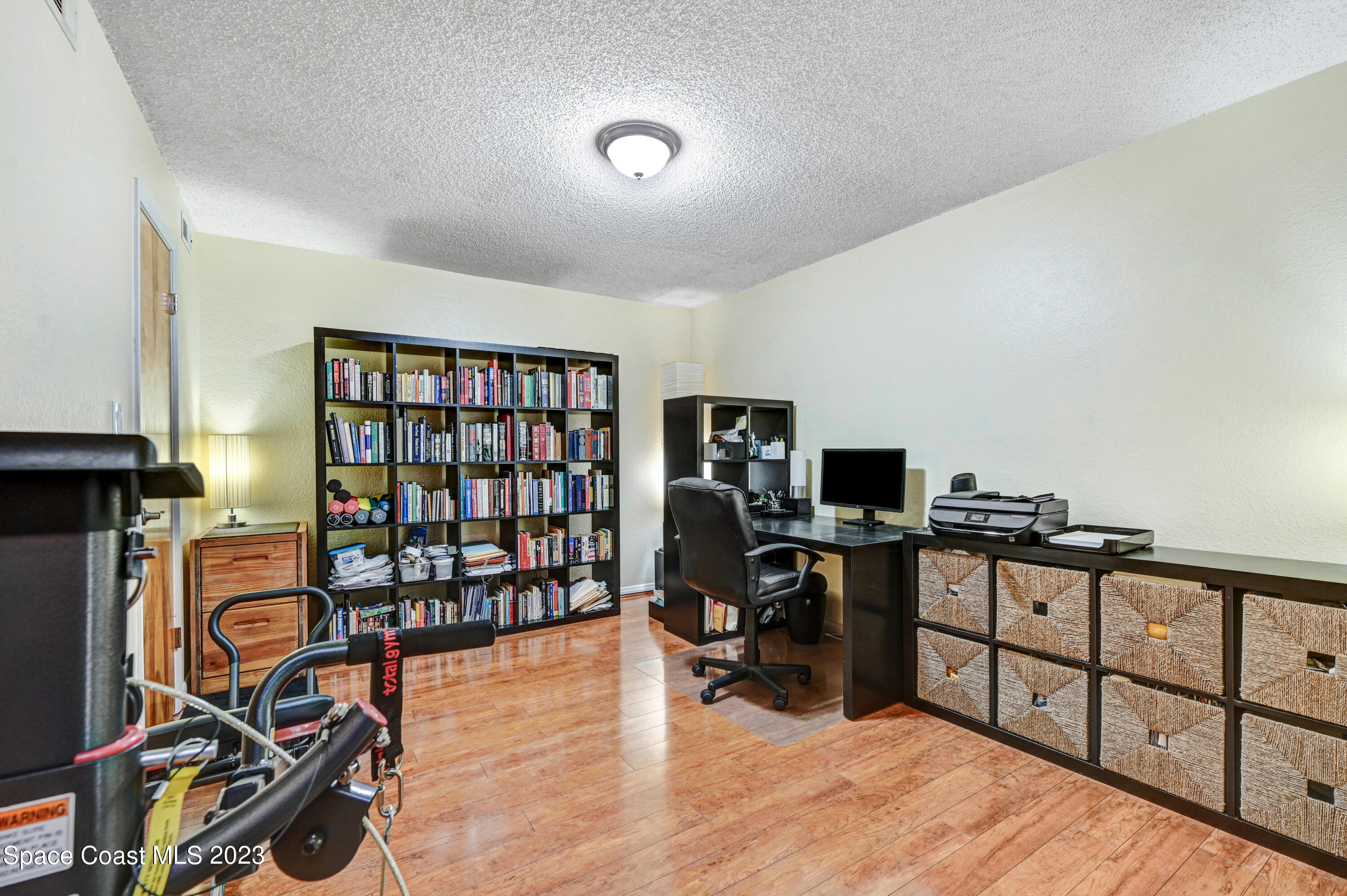 229 Augusta Way Melbourne, FL 32940 - Photo 15 of 39 a view of a workspace with furniture and wooden floor