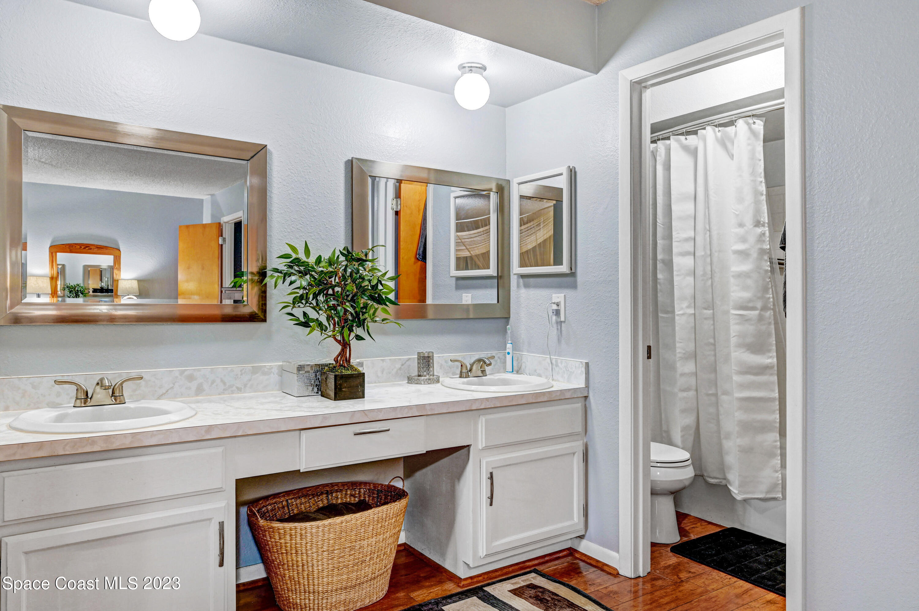 229 Augusta Way Melbourne, FL 32940 - Photo 20 of 39 a bathroom with a sink a toilet and a mirror