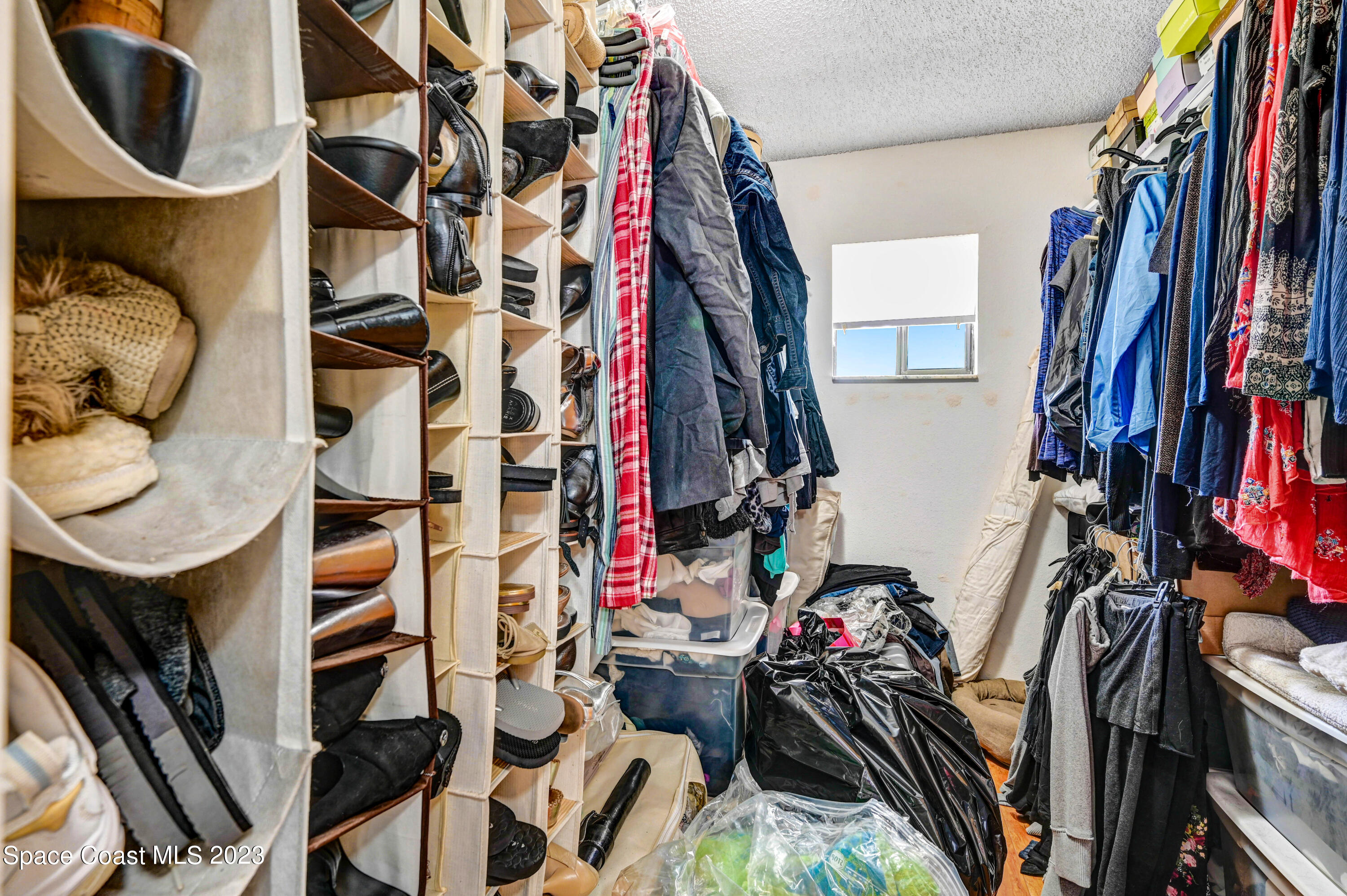 229 Augusta Way Melbourne, FL 32940 - Photo 26 of 39 a view of walk in closet with clothes and shoes