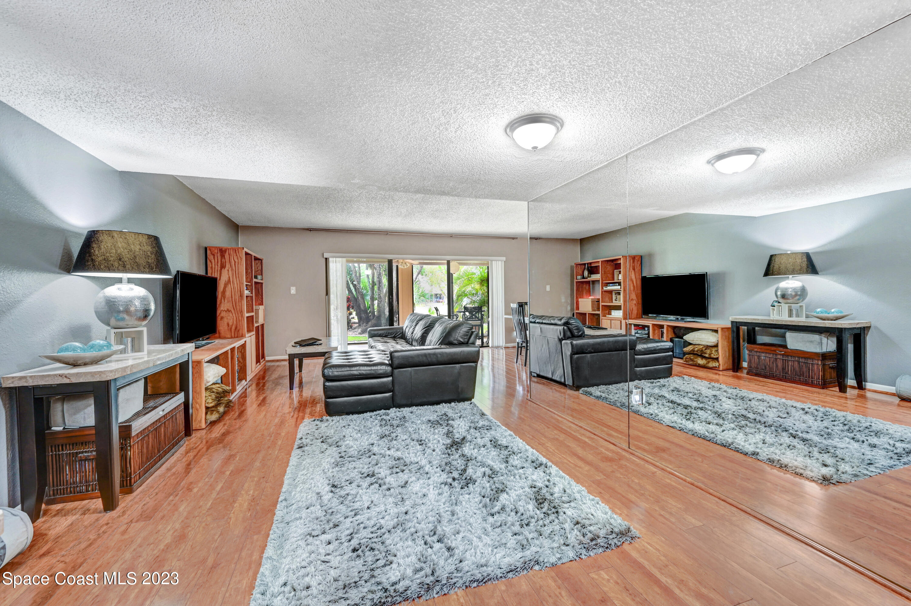 229 Augusta Way Melbourne, FL 32940 - Photo 4 of 39 a living room with furniture and a flat screen tv