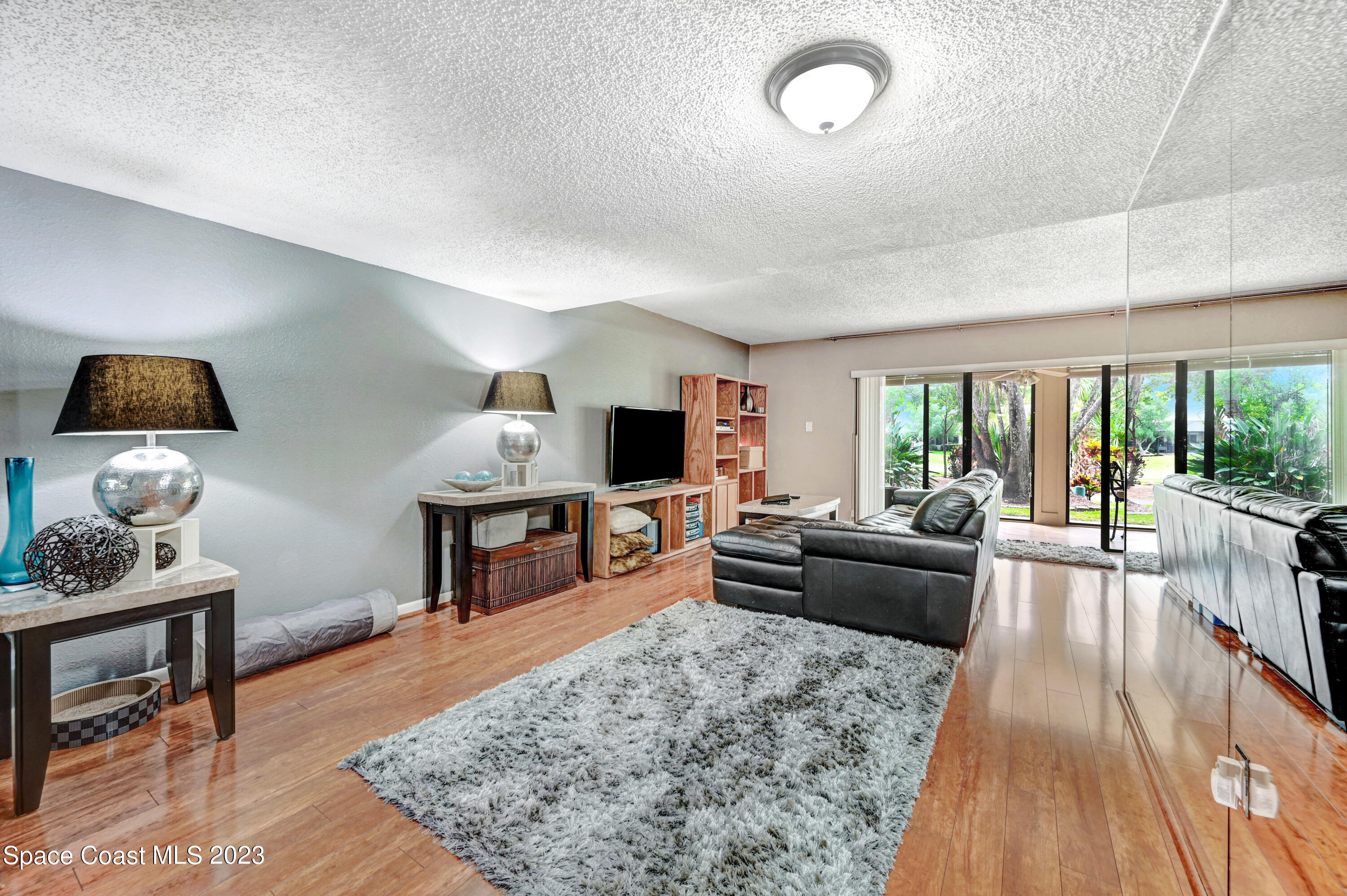 229 Augusta Way Melbourne, FL 32940 - Photo 5 of 39 a living room with furniture and a flat screen tv