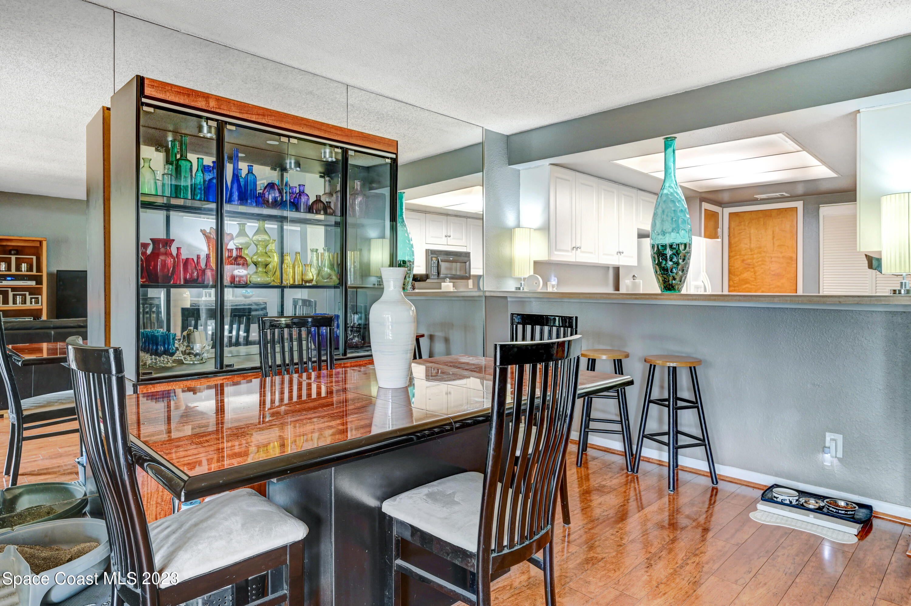 229 Augusta Way Melbourne, FL 32940 - Photo 8 of 39 a dining room with furniture a chandelier and wooden floor