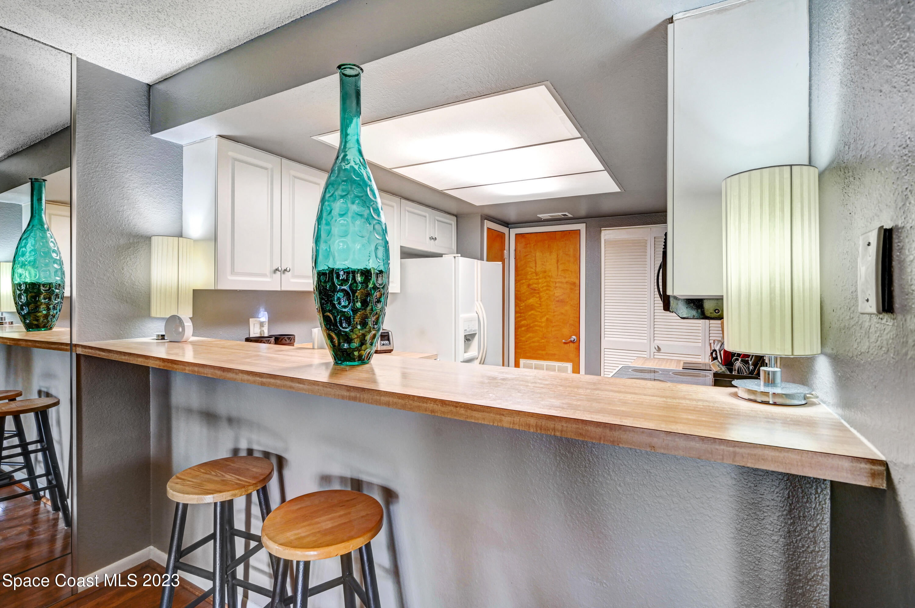 229 Augusta Way Melbourne, FL 32940 - Photo 10 of 39 a kitchen with stainless steel appliances a table and chairs in it
