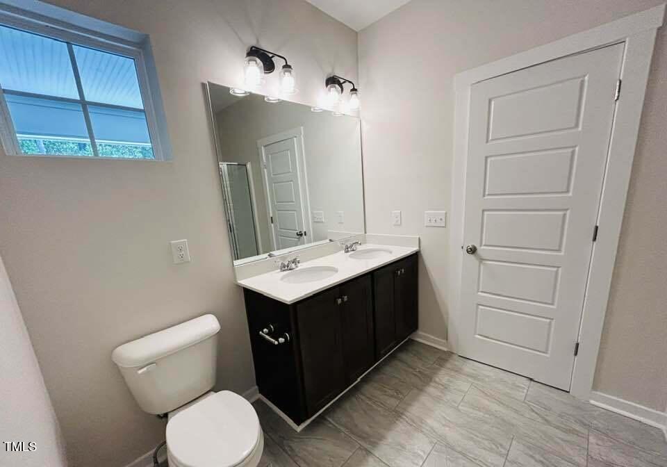 816 Laurel Gate Drive Wake Forest, NC 27587 - Photo 13 of 20 a bathroom with a toilet sink and mirror
