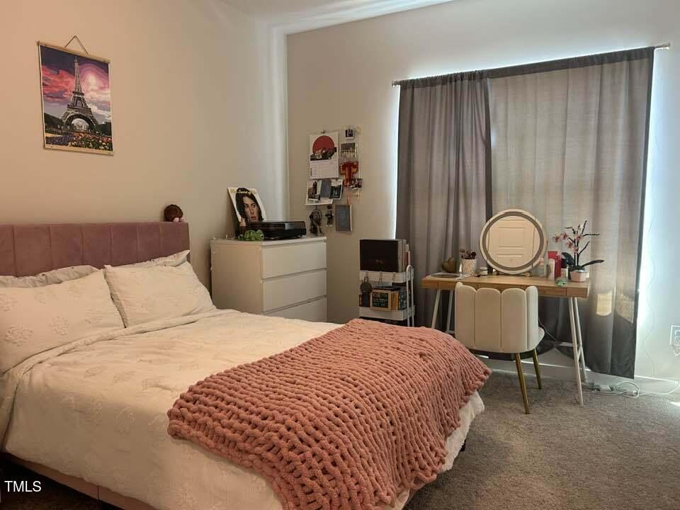 816 Laurel Gate Drive Wake Forest, NC 27587 - Photo 14 of 20 a bedroom with a bed and a table in it