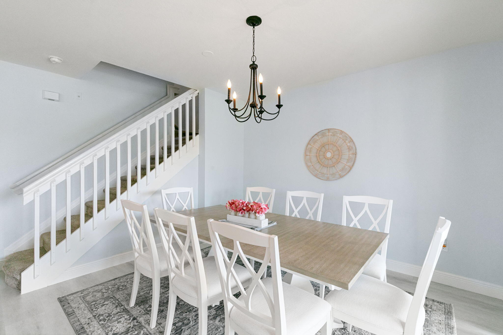 15068 Summit Pl Circle Naples, FL 34119 - Photo 11 of 29 a view of a dining room with furniture a chandelier and wooden floor