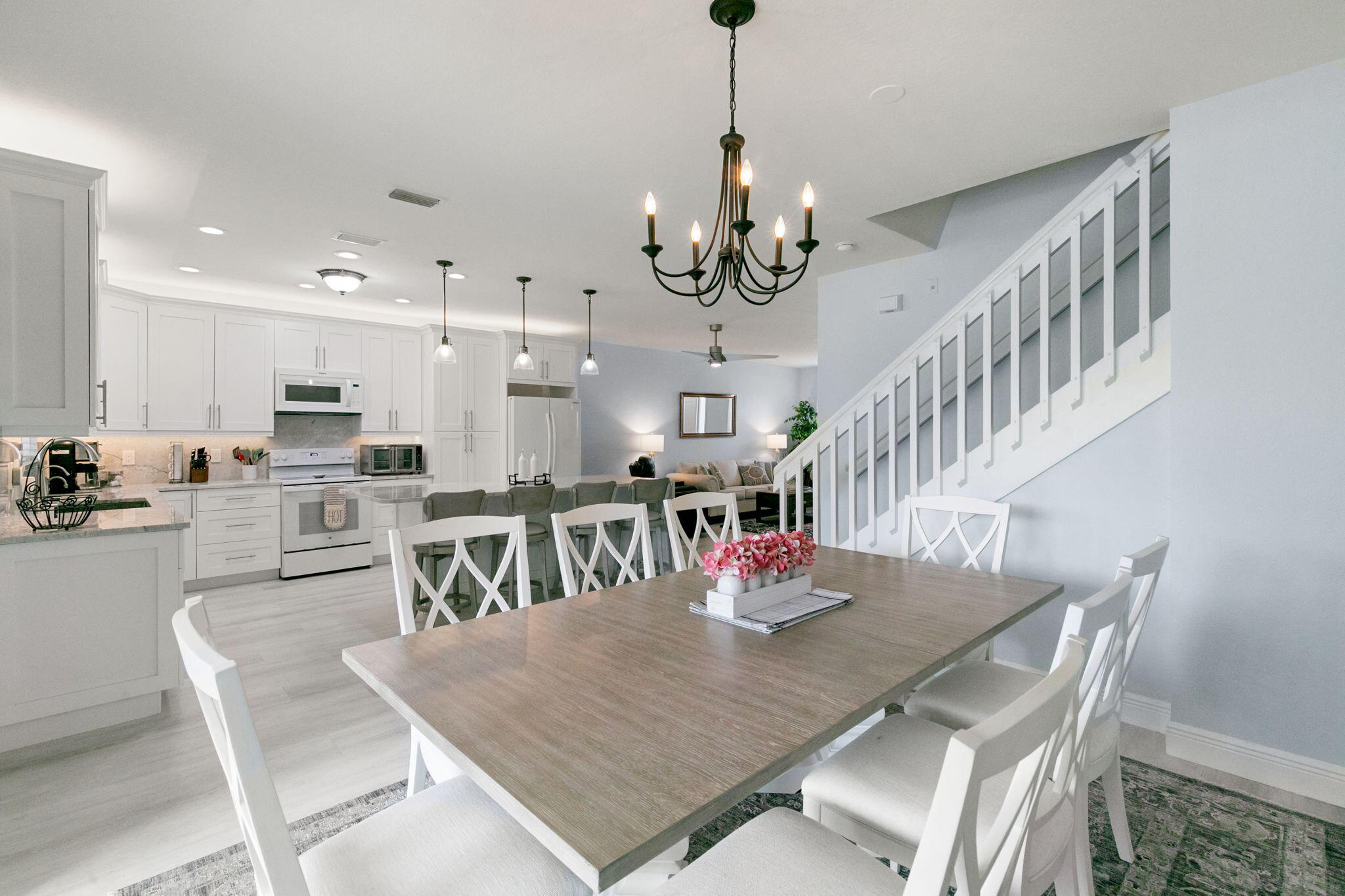 15068 Summit Pl Circle Naples, FL 34119 - Photo 12 of 29 a view of a dining room and livingroom with furniture wooden floor a chandelier