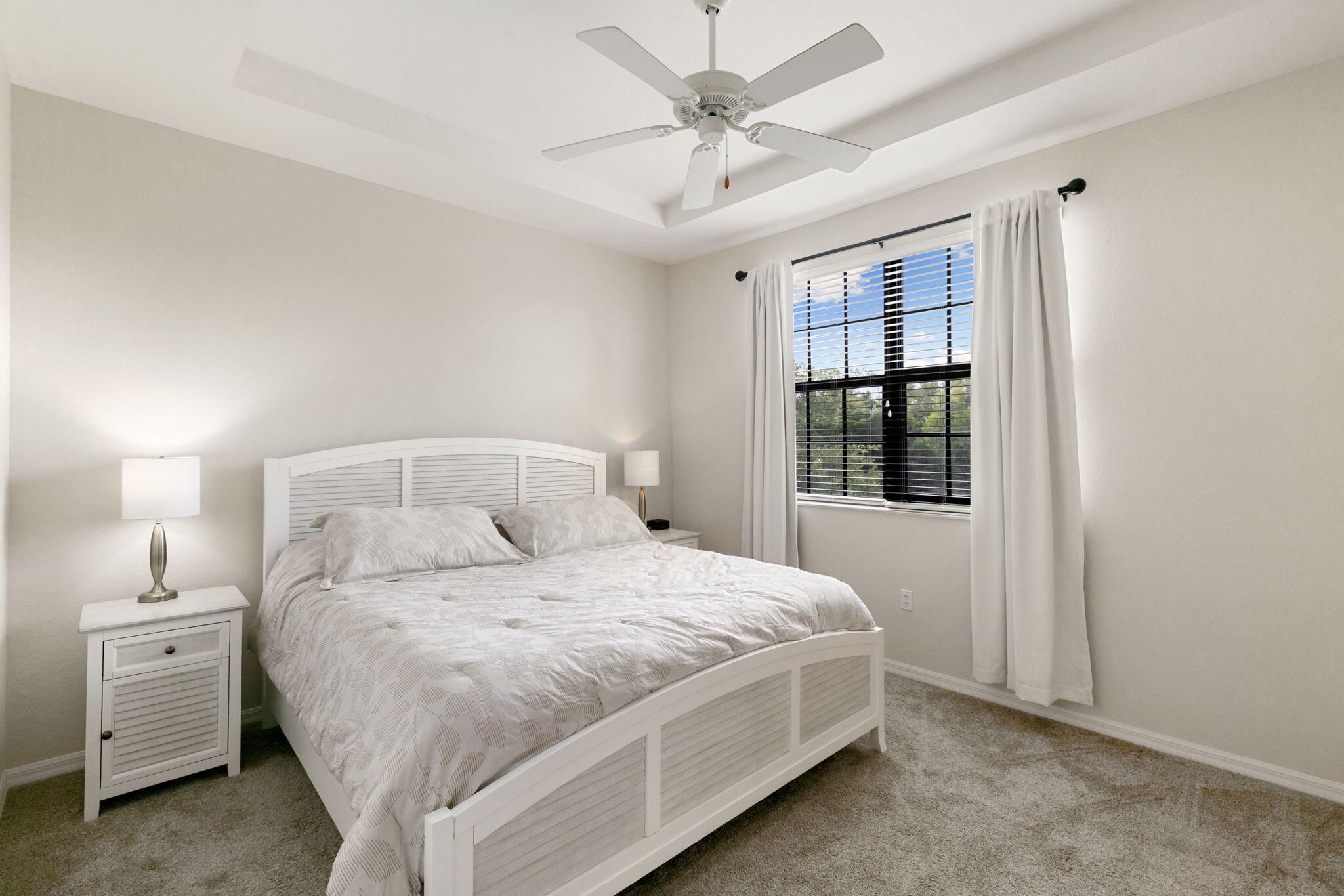 15068 Summit Pl Circle Naples, FL 34119 - Photo 13 of 29 a bedroom with a large bed and a window