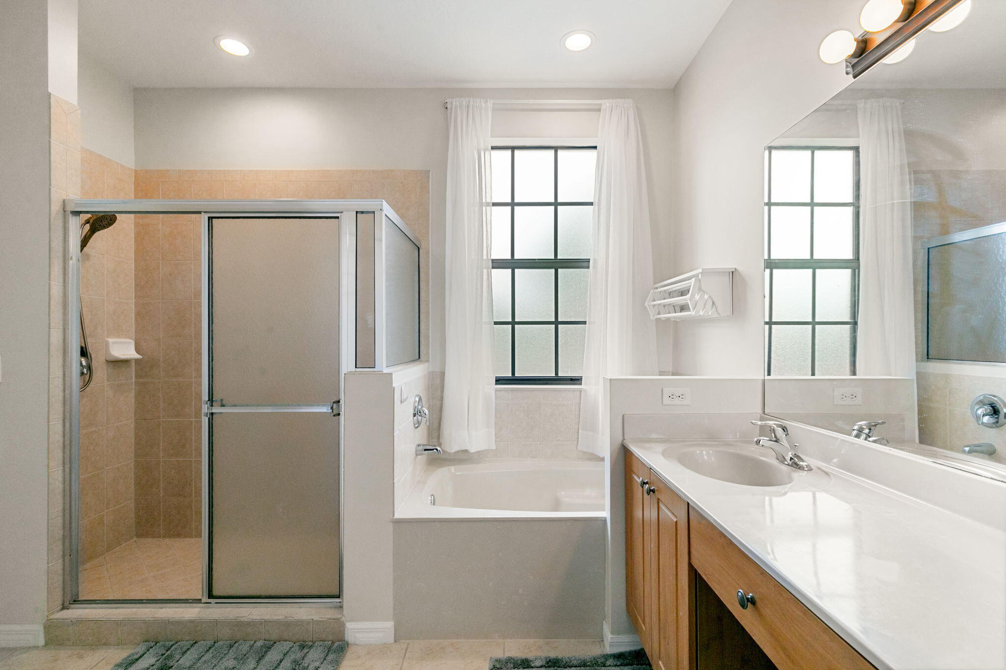 15068 Summit Pl Circle Naples, FL 34119 - Photo 16 of 29 a bathroom with a tub sink and shower