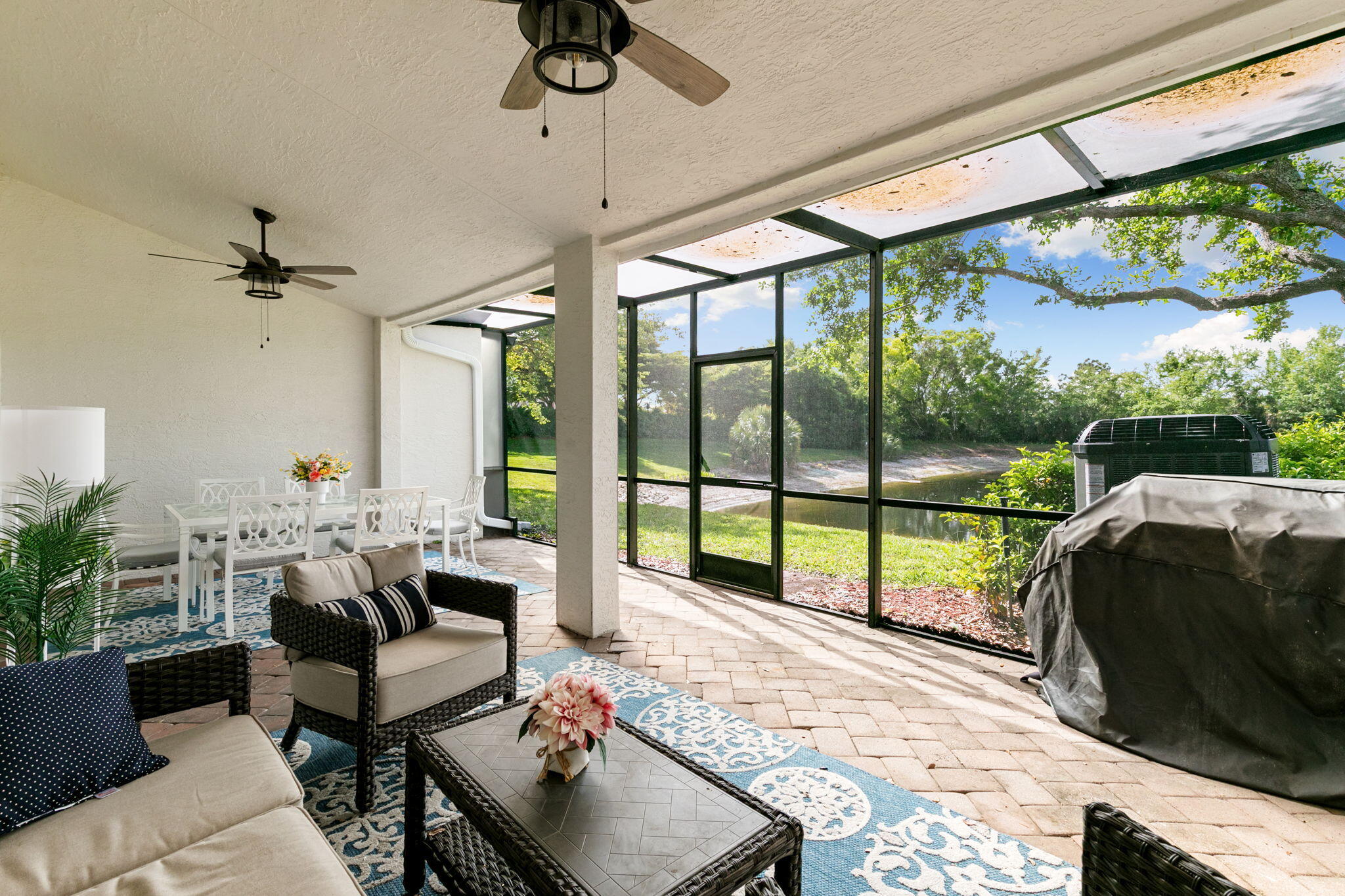 15068 Summit Pl Circle Naples, FL 34119 - Photo 22 of 29 a living room with furniture and a floor to ceiling window
