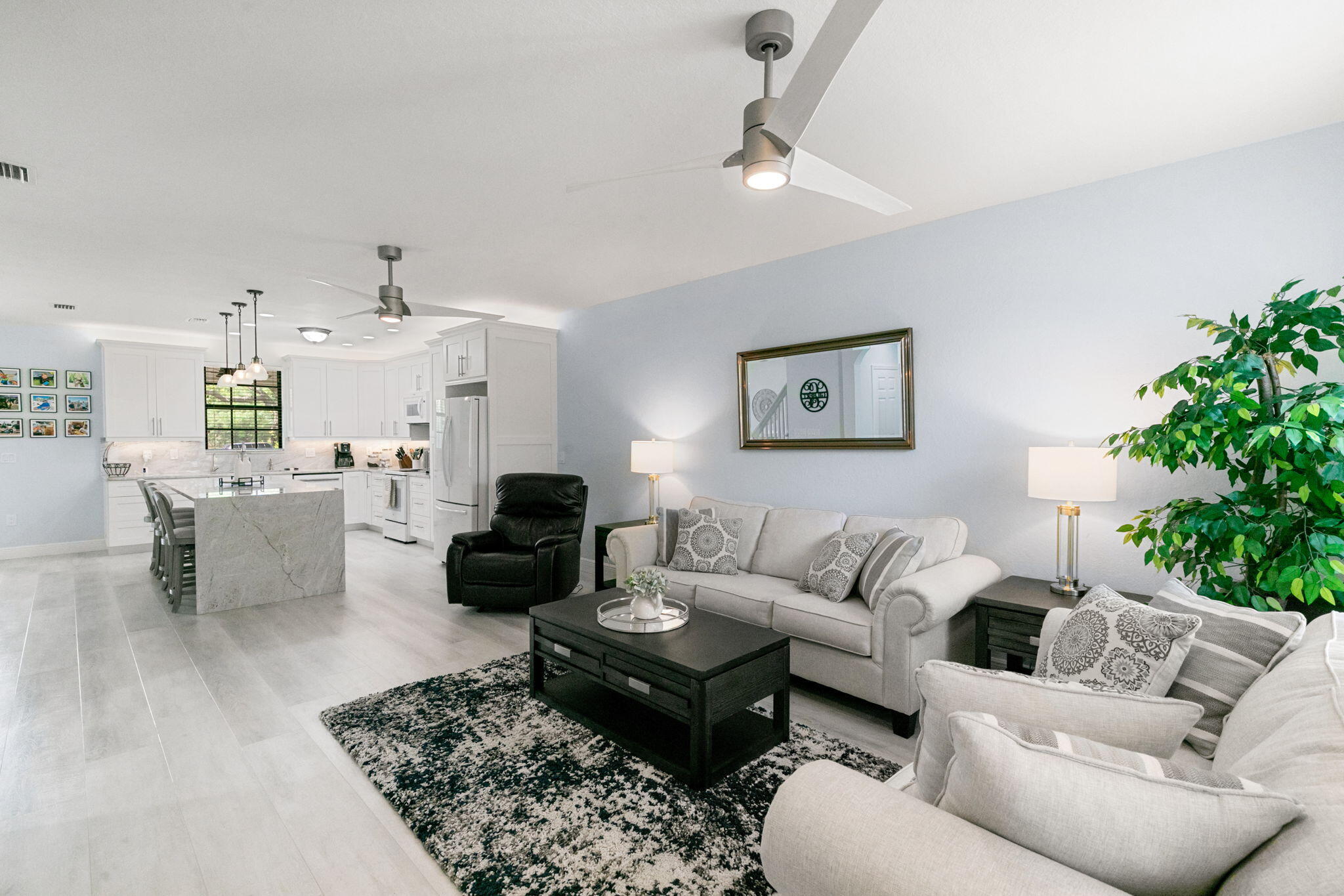 15068 Summit Pl Circle Naples, FL 34119 - Photo 4 of 29 a living room with furniture and a potted plant