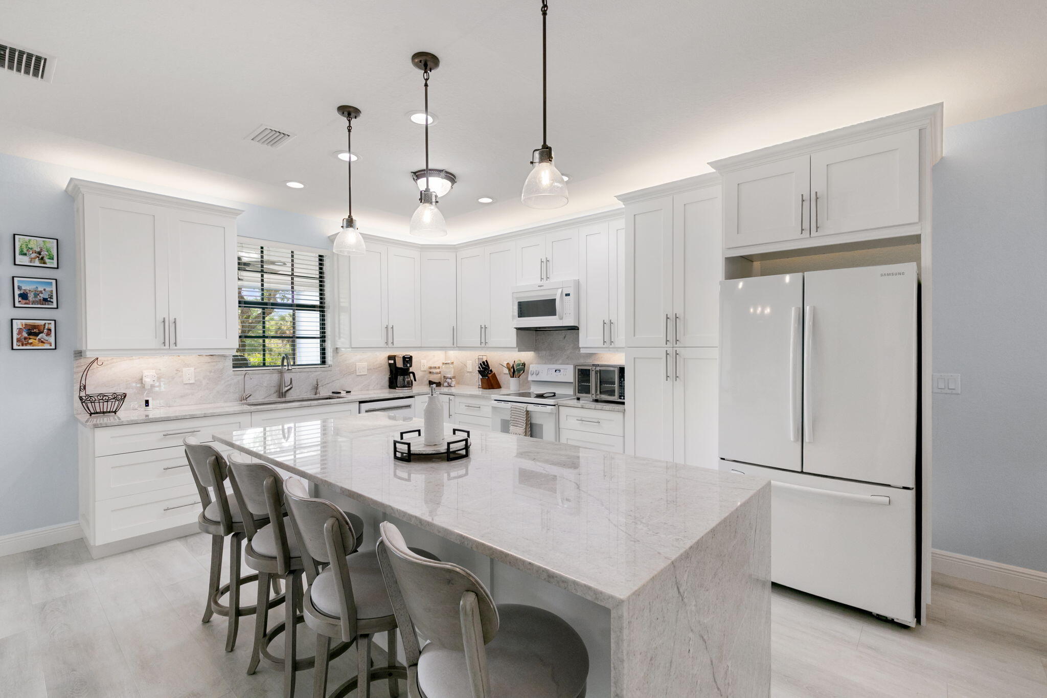 15068 Summit Pl Circle Naples, FL 34119 - Photo 5 of 29 a kitchen with kitchen island a appliances dining table and chairs