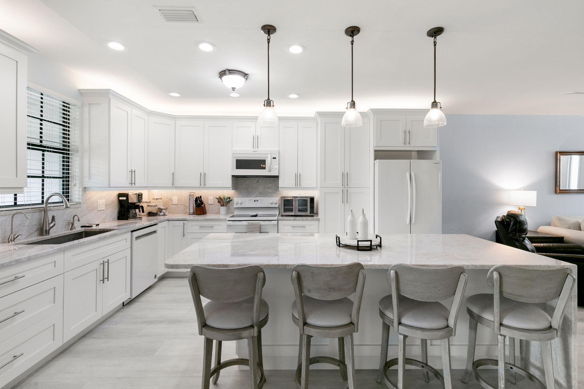 15068 Summit Pl Circle Naples, FL 34119 - Photo 6 of 29 a kitchen with stainless steel appliances kitchen island granite countertop a sink and cabinets