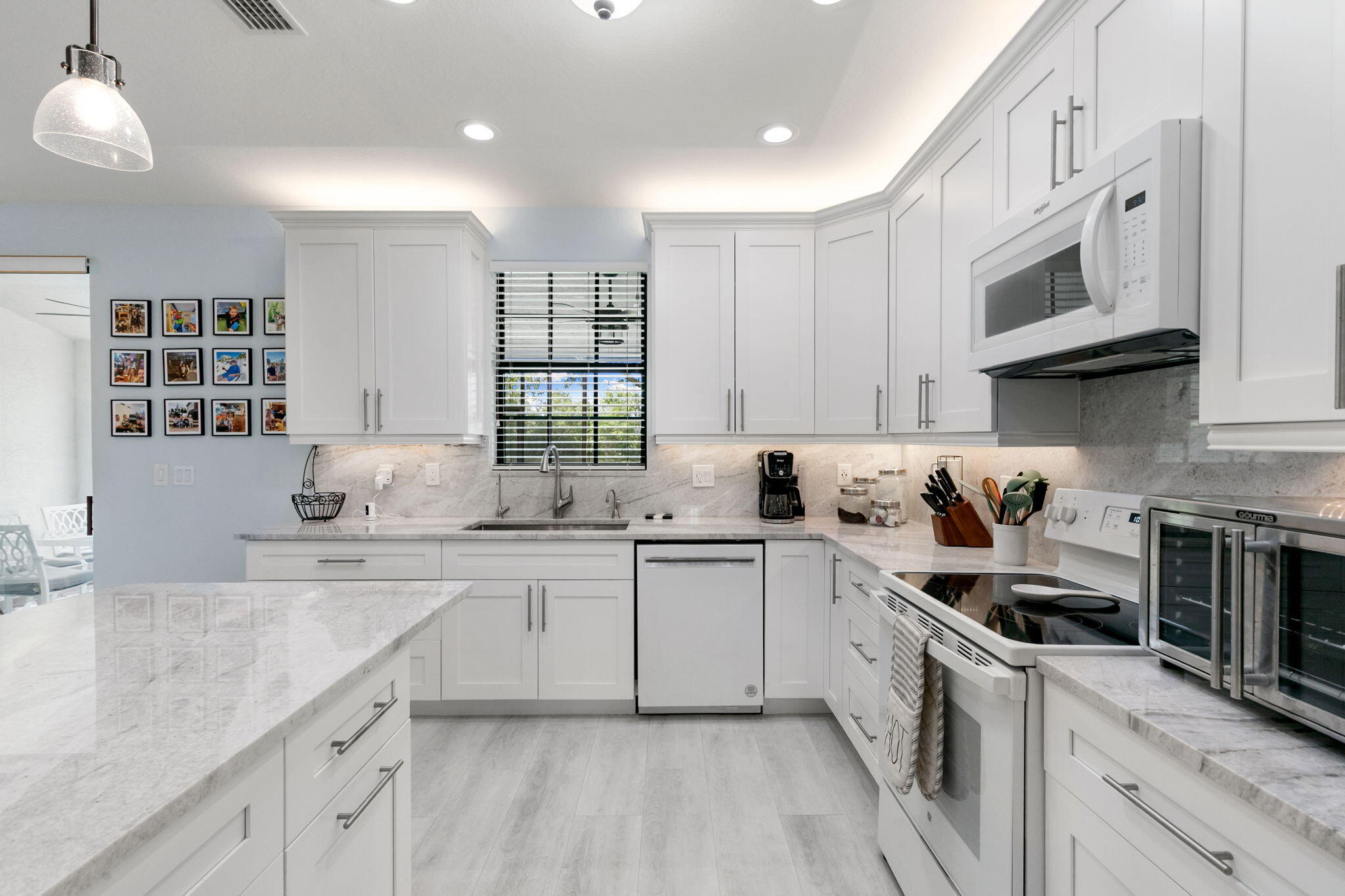 15068 Summit Pl Circle Naples, FL 34119 - Photo 9 of 29 a kitchen with stainless steel appliances granite countertop a sink and cabinets