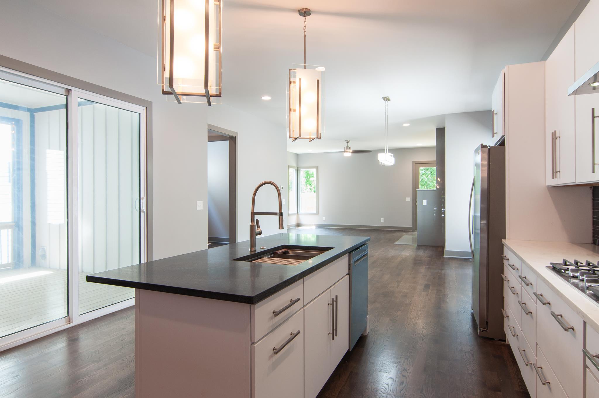 904 B Riverside Drive Nashville, TN 37206 - Photo 5 of 30 a kitchen with stainless steel appliances granite countertop a sink stove and refrigerator