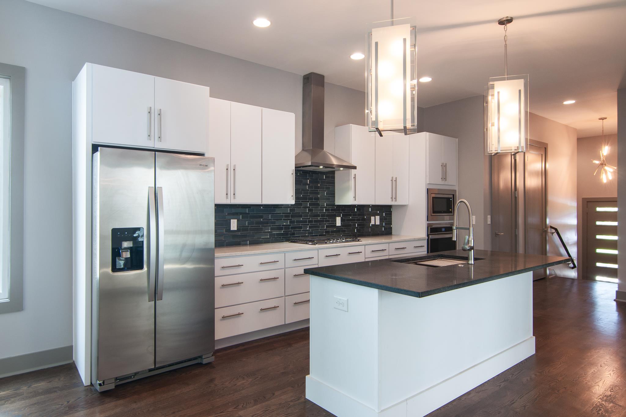 904 B Riverside Drive Nashville, TN 37206 - Photo 6 of 30 a kitchen with stainless steel appliances granite countertop a refrigerator a sink and white cabinets