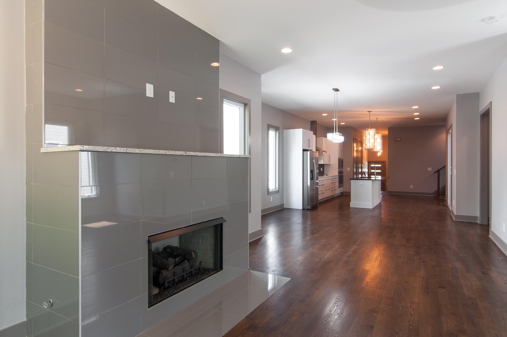 904 B Riverside Drive Nashville, TN 37206 - Photo 10 of 30 a view of a big room with wooden floor and a kitchen