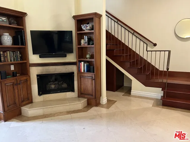 a living room with fireplace furniture and a flat screen tv