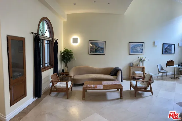 a living room with furniture a large window and a flat screen tv