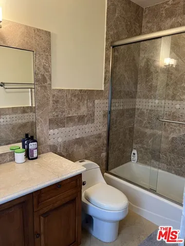 a bathroom with a sink a toilet and bathtub