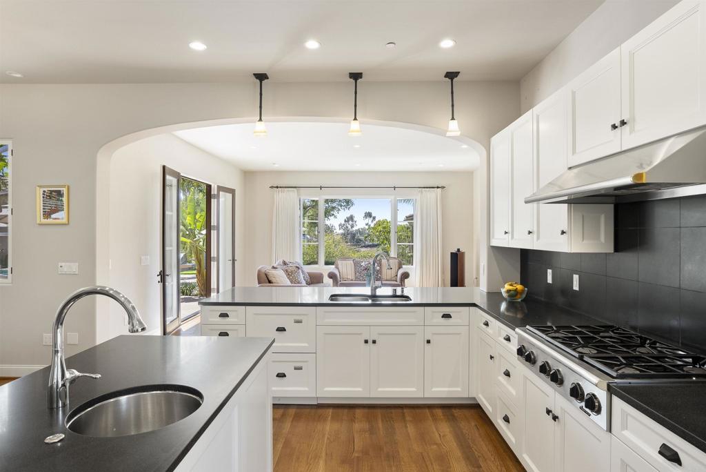 16733 Calle Hermosa San Diego, CA 92127 - Photo 16 of 43 a kitchen with kitchen island granite countertop a sink stainless steel appliances and cabinets