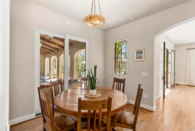 a view of a dining room with furniture wooden floor and chandelier