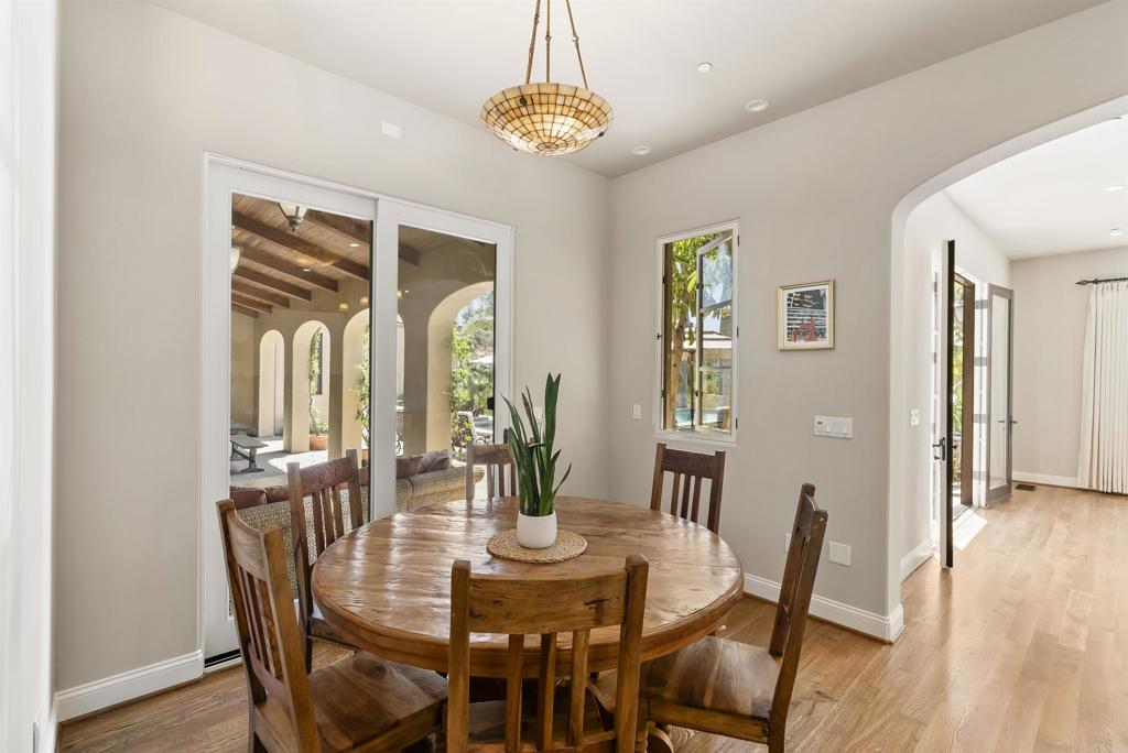 16733 Calle Hermosa San Diego, CA 92127 - Photo 17 of 43 a view of a dining room with furniture wooden floor and chandelier
