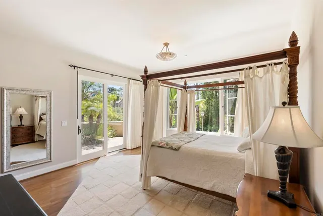 a bedroom with a bed and large window