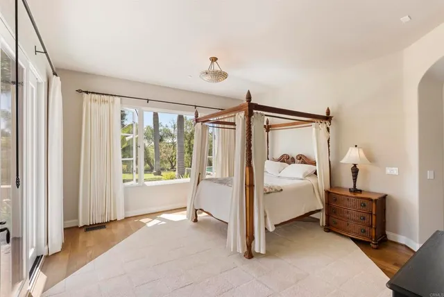 a spacious bedroom with a bed and a window