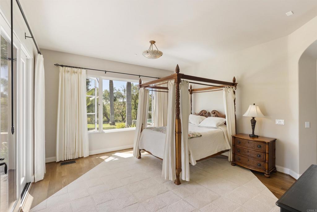 16733 Calle Hermosa San Diego, CA 92127 - Photo 24 of 43 a spacious bedroom with a bed and a window