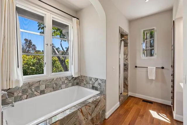 a bathroom with a bathtub and a shower