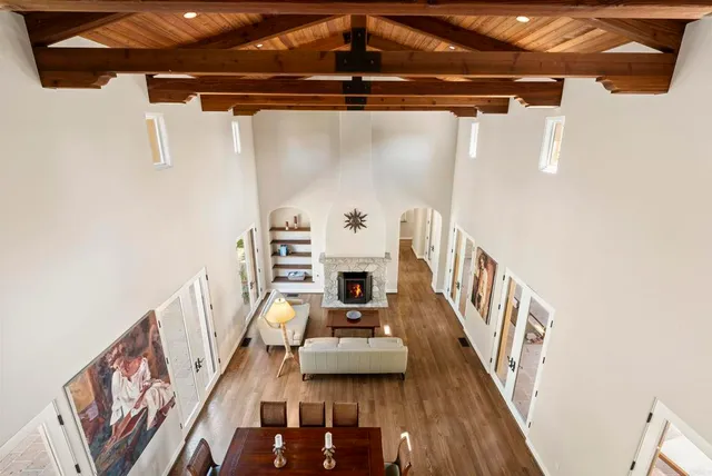 a view of a livingroom with furniture staircase and front door