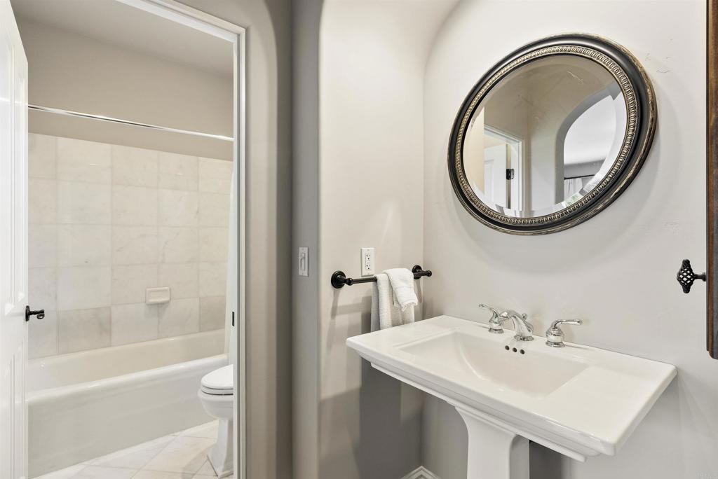 16733 Calle Hermosa San Diego, CA 92127 - Photo 32 of 43 a bathroom with a sink a toilet and a mirror